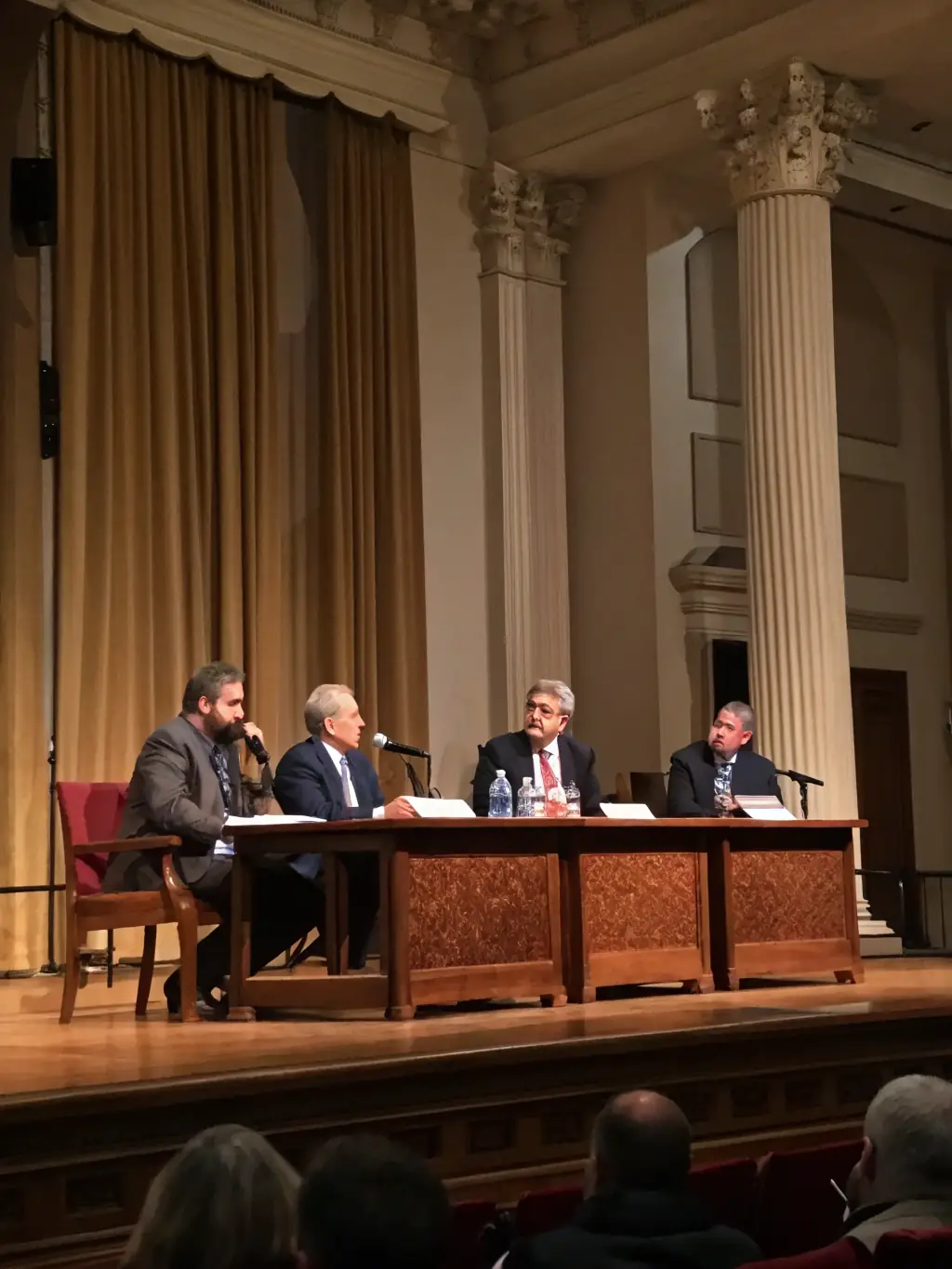 A photograph of the Cape Town International Convention Centre, showcasing a panel discussion during a cybersecurity conference. The image should highlight the expertise and insights shared by the speakers.